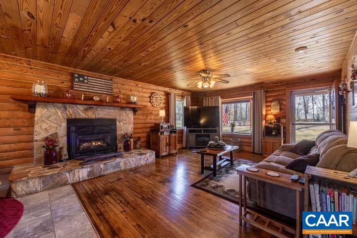 5880 Mechunk Ridge Lane Keswick, VA 22947 - Photo 13 of 38 a living room with furniture a fireplace and a table