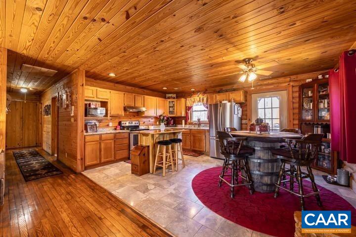 5880 Mechunk Ridge Lane Keswick, VA 22947 - Photo 18 of 38 a room with lots of wooden furniture and stainless steel appliances