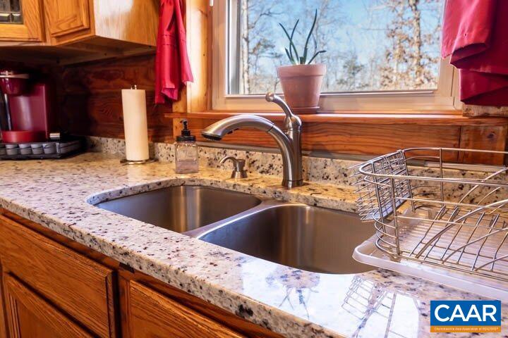5880 Mechunk Ridge Lane Keswick, VA 22947 - Photo 19 of 38 a view of a kitchen counter top space with a sink and chandelier