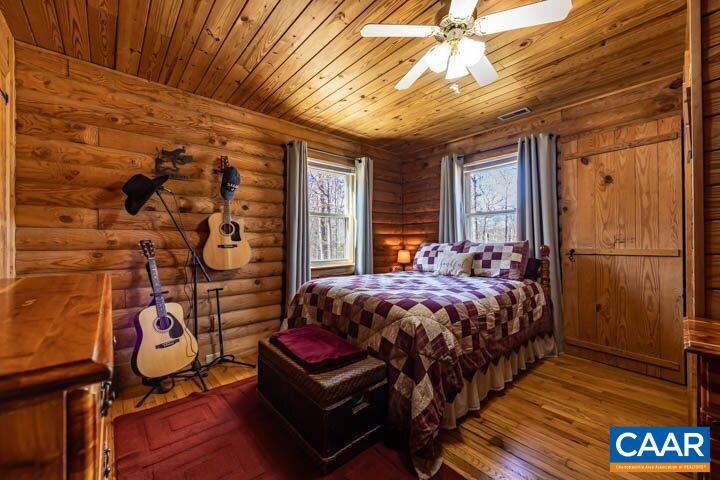 5880 Mechunk Ridge Lane Keswick, VA 22947 - Photo 24 of 38 a bed sitting in a bedroom next to a window