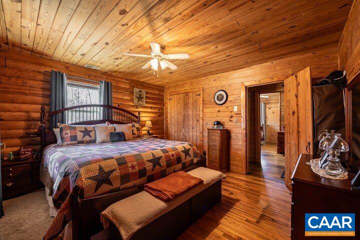 5880 Mechunk Ridge Lane Keswick, VA 22947 - Photo 26 of 38 a bedroom with a bed and wooden floor