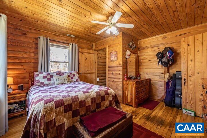 5880 Mechunk Ridge Lane Keswick, VA 22947 - Photo 27 of 38 a bedroom with a bed and a table