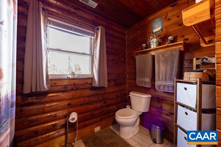 5880 Mechunk Ridge Lane Keswick, VA 22947 - Photo 30 of 38 a bathroom with a toilet sink and mirror