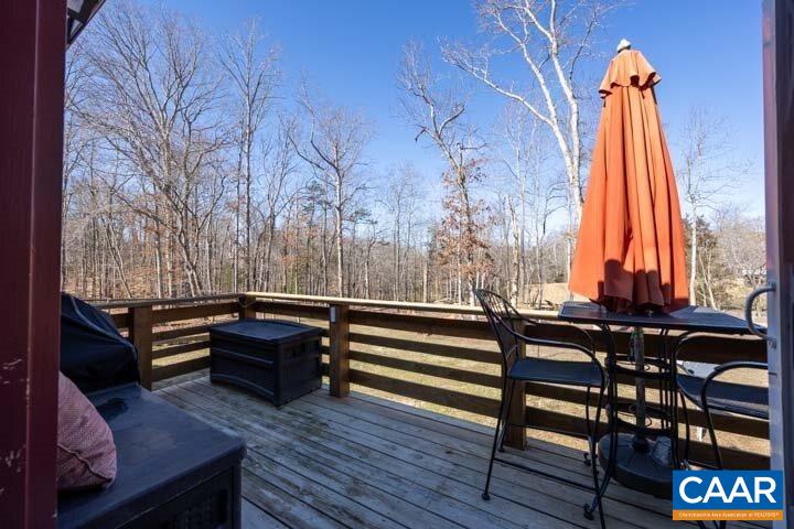5880 Mechunk Ridge Lane Keswick, VA 22947 - Photo 34 of 38 a view of deck with furniture and a backyard