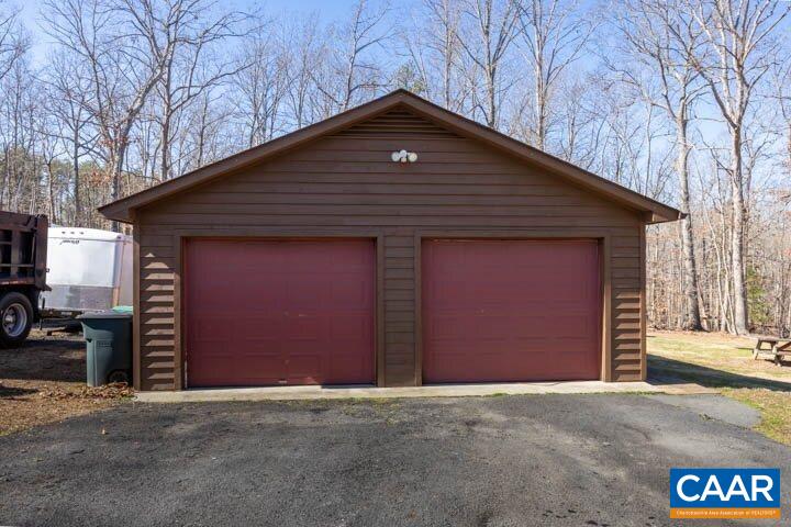 5880 Mechunk Ridge Lane Keswick, VA 22947 - Photo 6 of 38 a front view of a house with a garage
