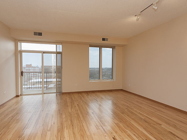 515 Main Street, Unit 707 Evanston, IL 60202 - Photo 3 of 12 wooden floor in an empty room with a window