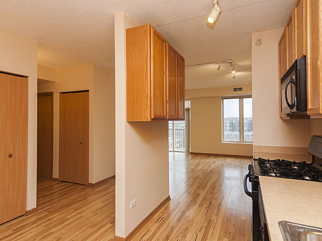 515 Main Street, Unit 707 Evanston, IL 60202 - Photo 5 of 12 a view of a kitchen with wooden floor and a sink