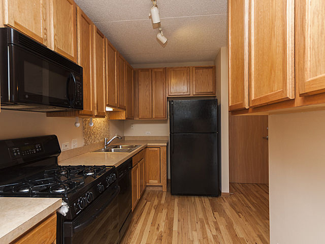 515 Main Street, Unit 707 Evanston, IL 60202 - Photo 6 of 12 a kitchen with a refrigerator stove and microwave