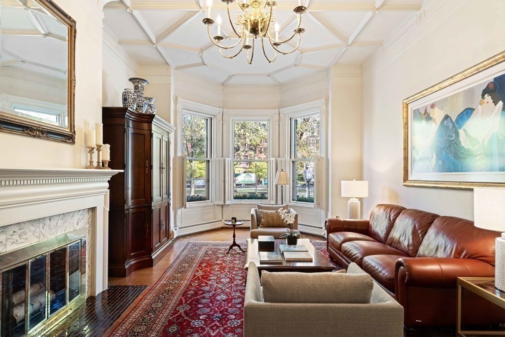 226 Commonwealth Avenue, Unit 1 Boston, MA 02116 - Photo 2 of 17 a living room with furniture a chandelier and a fireplace