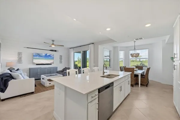 a bedroom with a bed and a lamp on dresser