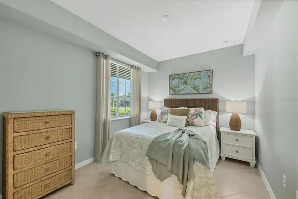 a living room with a floor to ceiling window and wooden floor