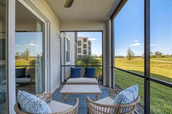 a view of a house with a big yard and a large tree