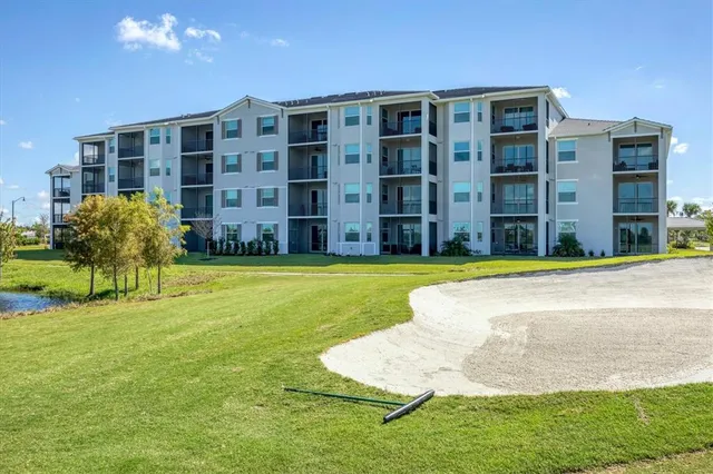 a view of a big room with a swimming pool and outdoor seating