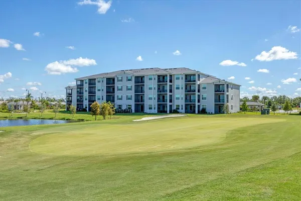 a front view of a house with a yard and potted plants