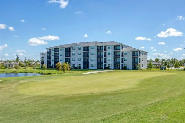 a front view of a house with a yard and potted plants