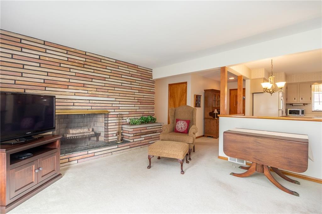 146 Ridgeview Drive Aliquippa, PA 15001 - Photo 2 of 20 Living room with plenty of space and open to the kitchen for easy entertaining. The stone wood burning fireplace is beautiful and makes for a grand focal point.