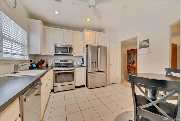 a kitchen with a stove a sink and a refrigerator
