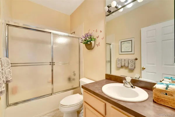 a bathroom with a sink toilet a mirror and shower