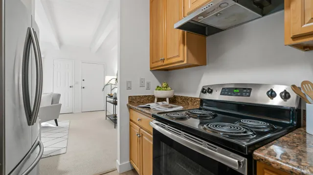a stove top oven sitting inside of a kitchen