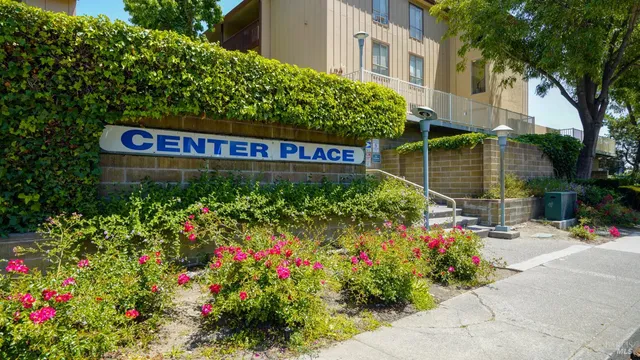 a view of sign board with buildings