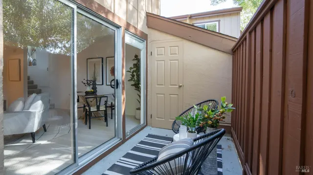 a view of a balcony and dining room