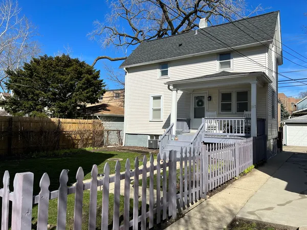 a view of a house with wooden fence