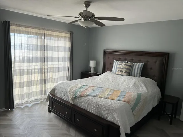 a bedroom with a bed and a chandelier