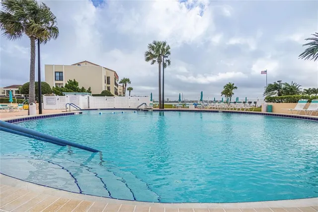 a view of a swimming pool with a yard