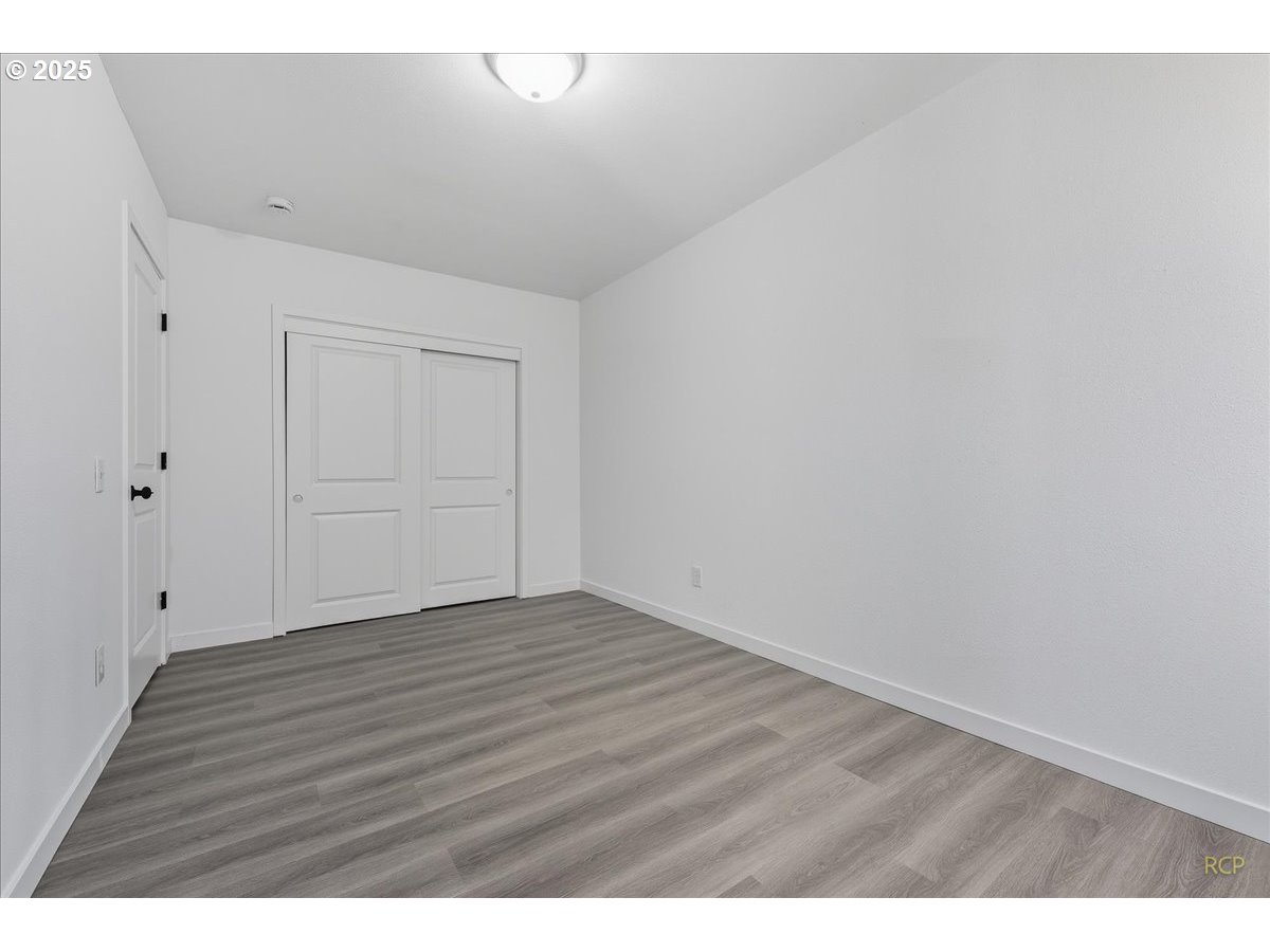 11420 Southeast Clinton Street Portland, OR 97266 - Photo 18 of 34 a view of an empty room with wooden floor