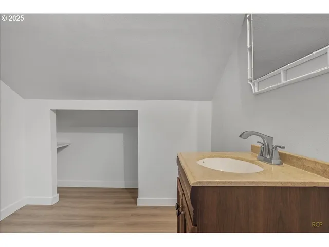 a bathroom with a sink vanity and a mirror