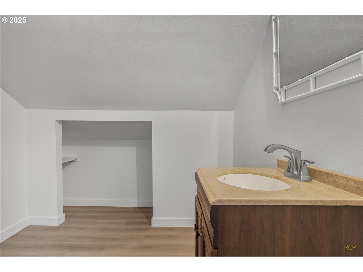 11420 Southeast Clinton Street Portland, OR 97266 - Photo 24 of 34 a bathroom with a sink vanity and a mirror