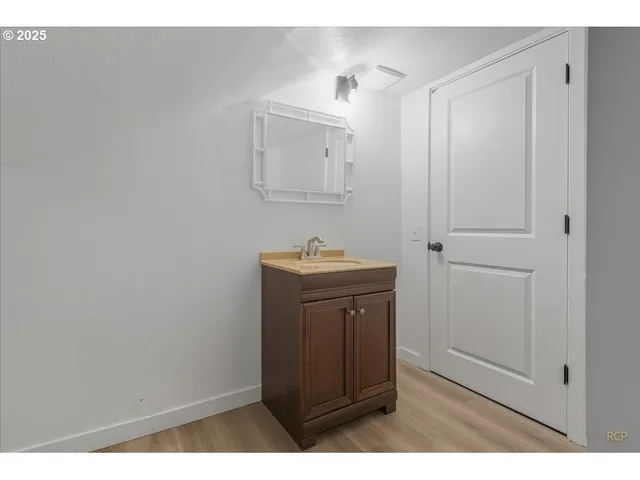 a bathroom with a sink a mirror and vanity