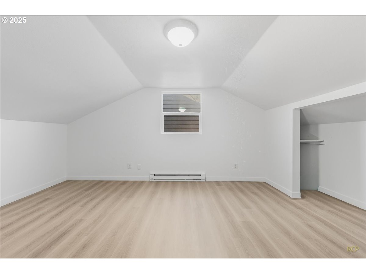 11420 Southeast Clinton Street Portland, OR 97266 - Photo 27 of 34 a view of an empty room with wooden floor and a window