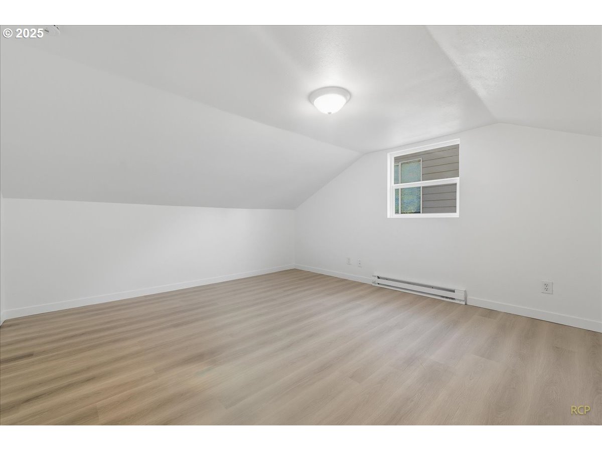 11420 Southeast Clinton Street Portland, OR 97266 - Photo 28 of 34 a view of an empty room with wooden floor and a window