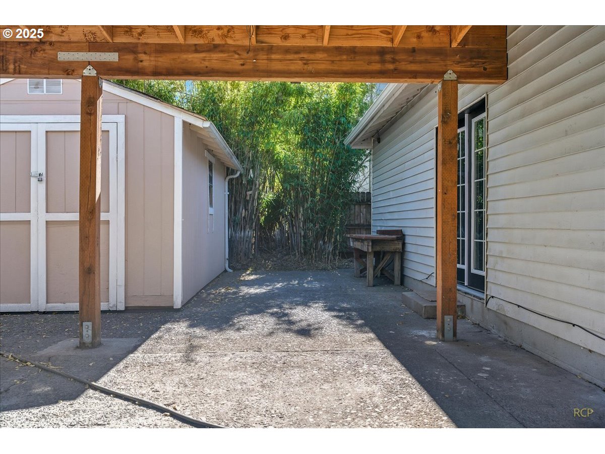 11420 Southeast Clinton Street Portland, OR 97266 - Photo 5 of 34 a backyard of a house with table and chairs