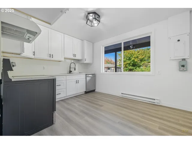 a kitchen with a sink cabinets and window