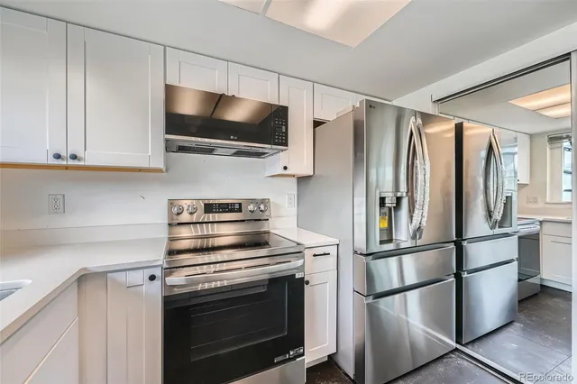 a kitchen with stainless steel appliances a refrigerator stove and microwave