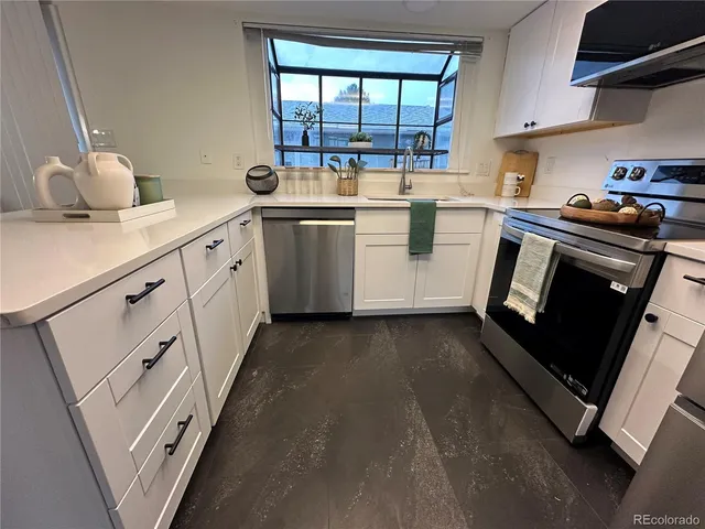 a kitchen with a sink stove and cabinets