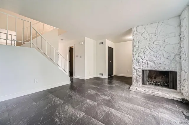 a view of empty room with fireplace