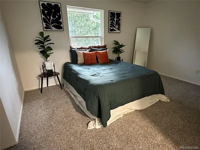 a bedroom with a bed and window