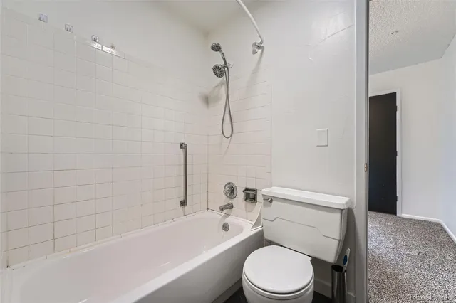 a bathroom with a toilet and a bath tub