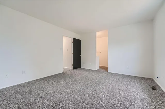 an empty room with closet area