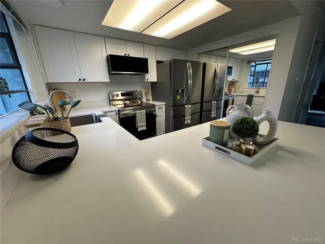 a kitchen with a sink a stove and refrigerator
