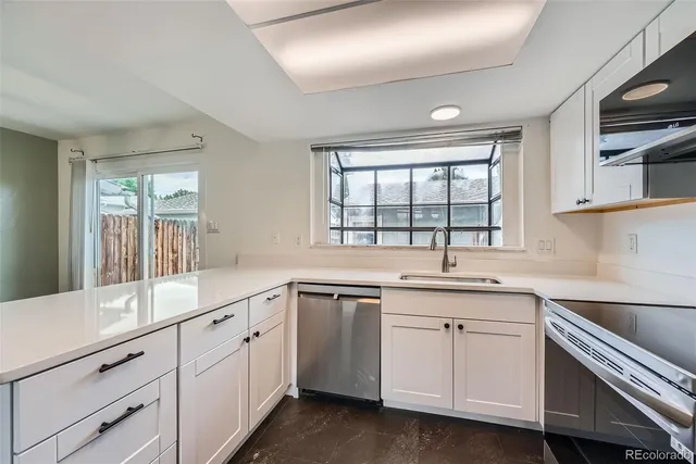 a kitchen with sink stove and cabinets