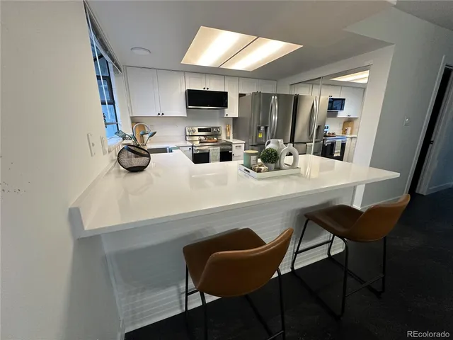 a kitchen with a dining table and chairs