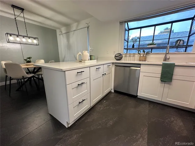 a kitchen with a cabinets and chandelier