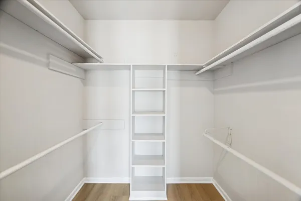 a view of walk in closet with empty racks