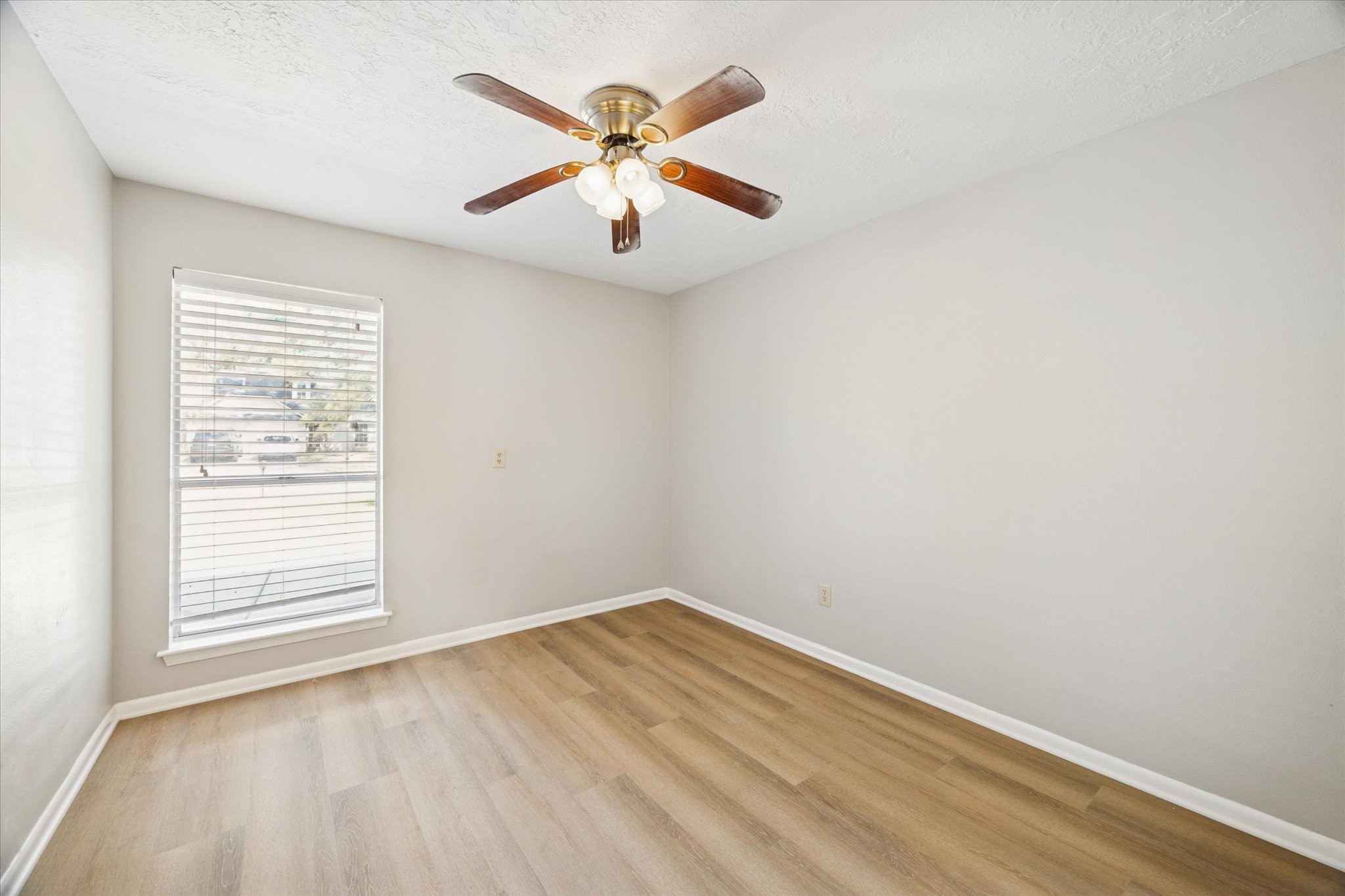 25903 Long Hill Lane Spring, TX 77373 - Photo 16 of 20 an empty room with a window and ceiling fan