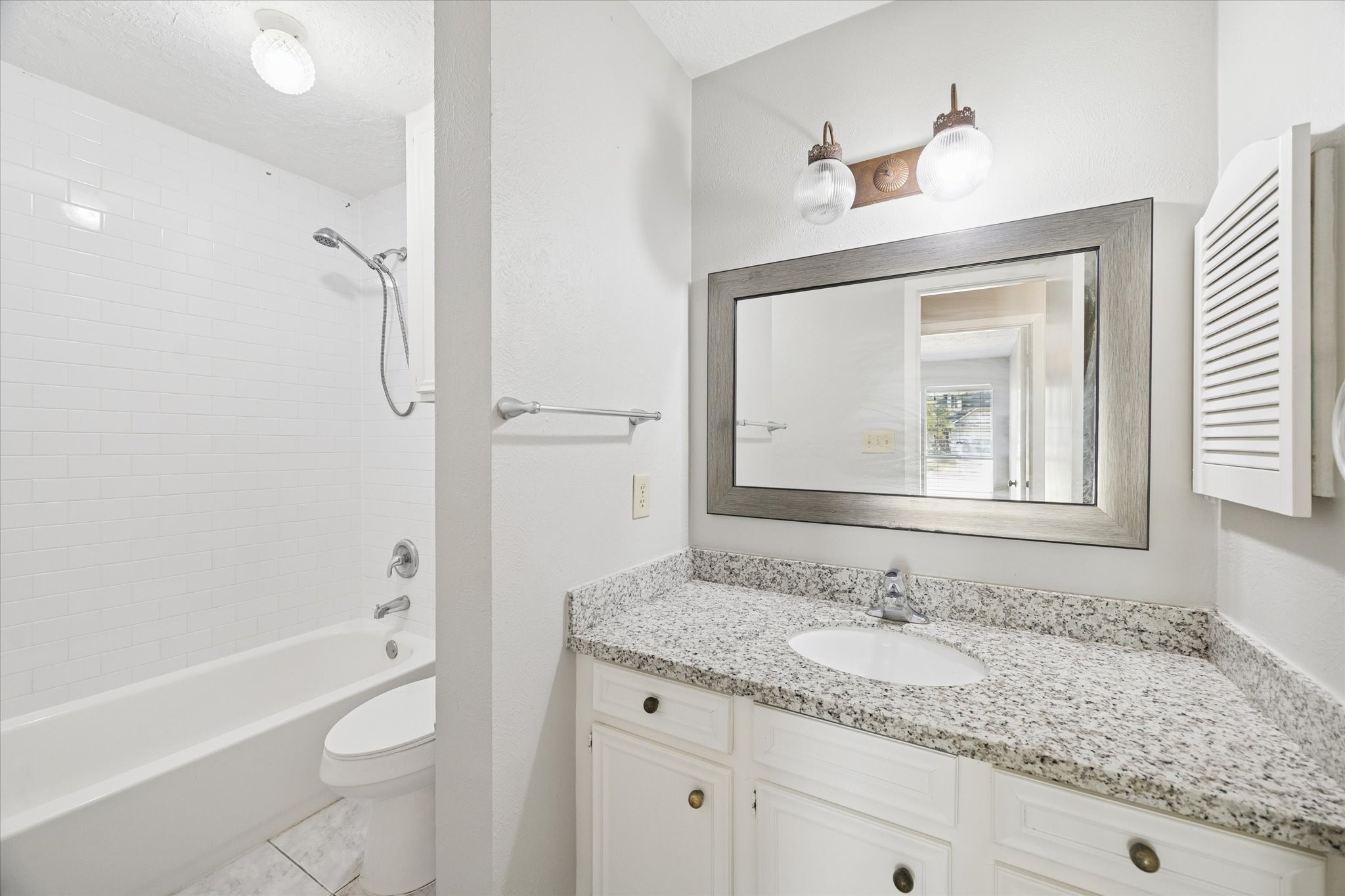 25903 Long Hill Lane Spring, TX 77373 - Photo 18 of 20 a bathroom with a granite countertop sink toilet and shower