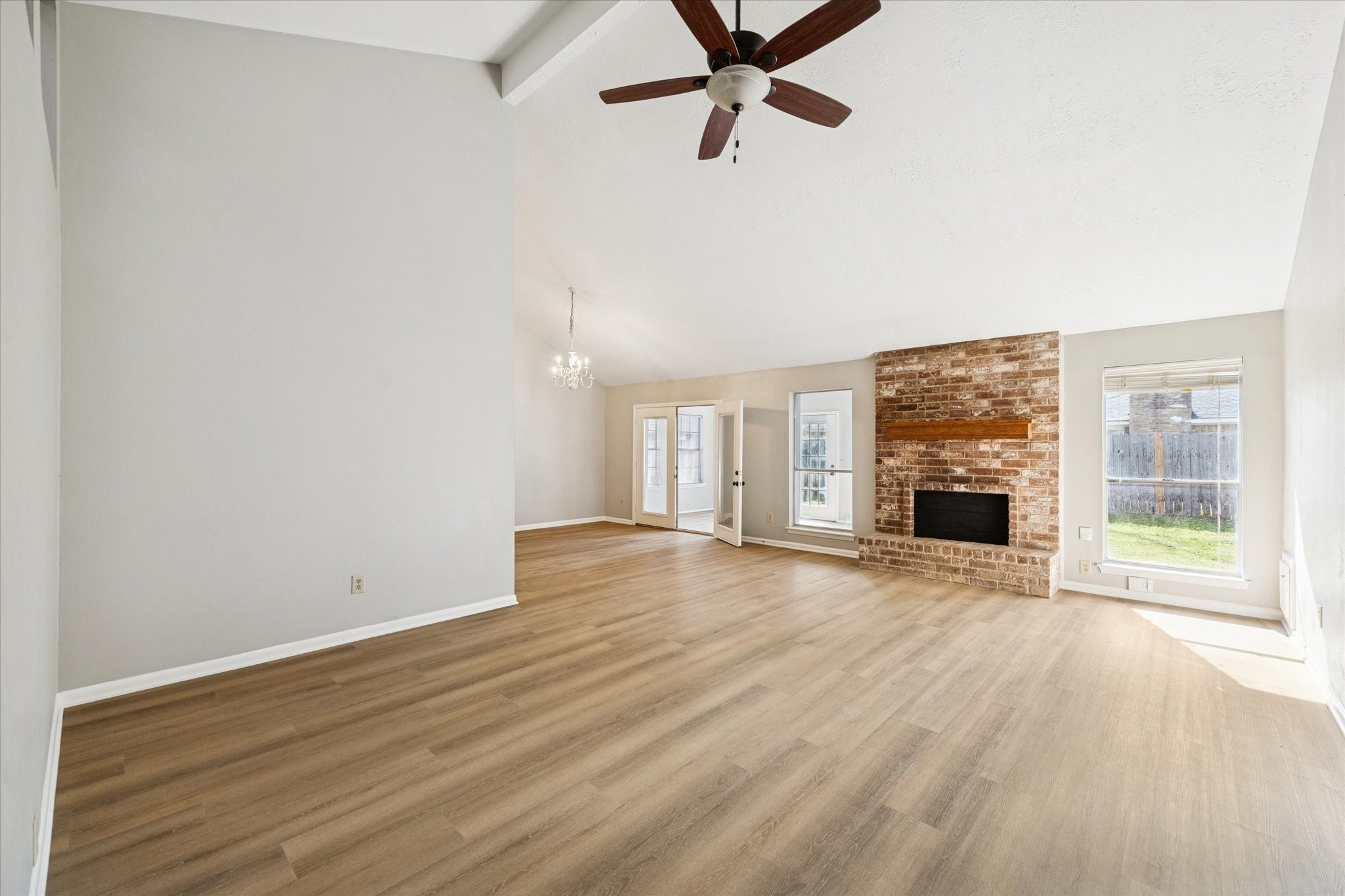 25903 Long Hill Lane Spring, TX 77373 - Photo 2 of 20 wooden floor fireplace and windows in an empty room